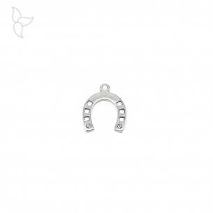 Small silvery horseshoe pendant .